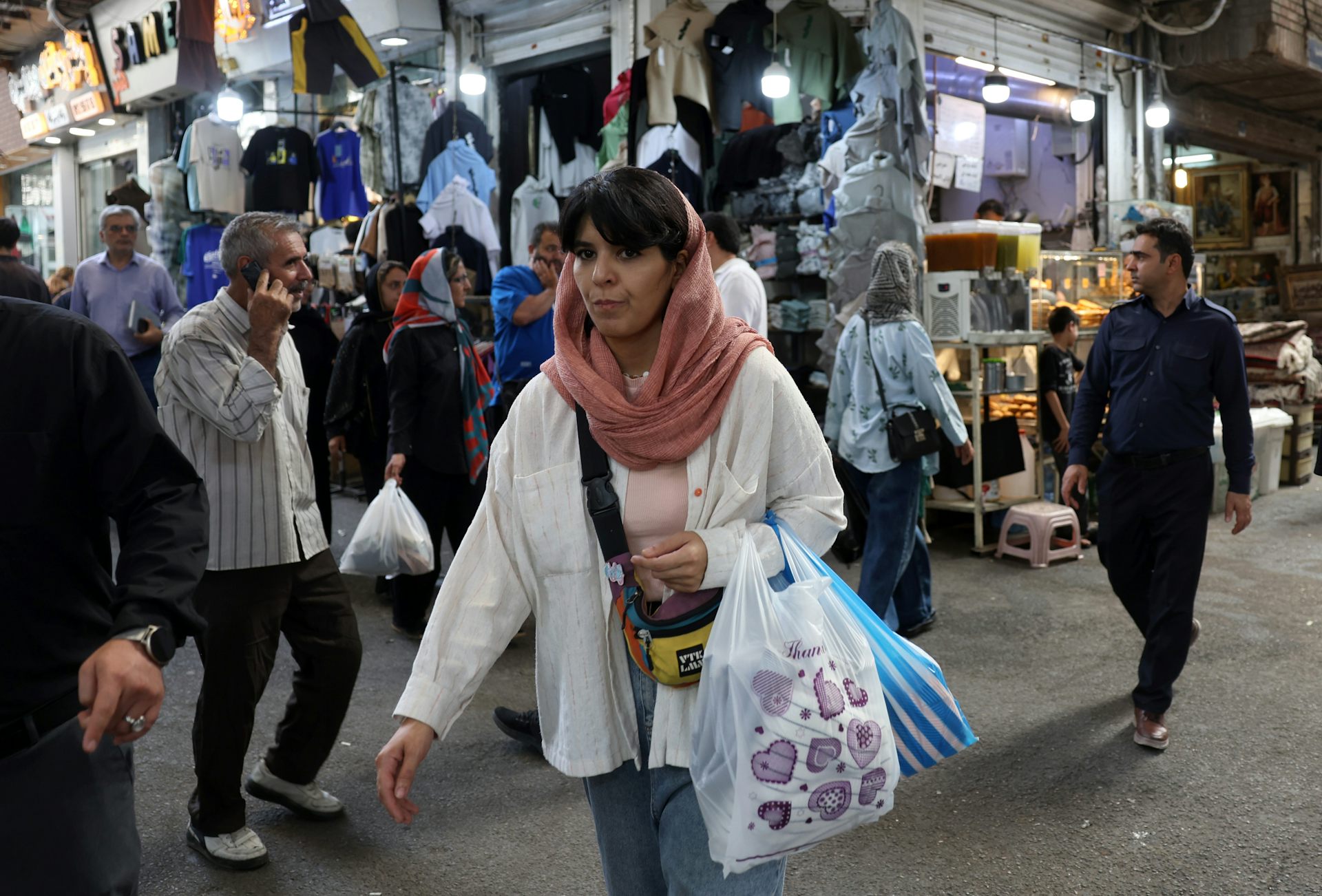 A woman walks through a bazaar in Tehran.