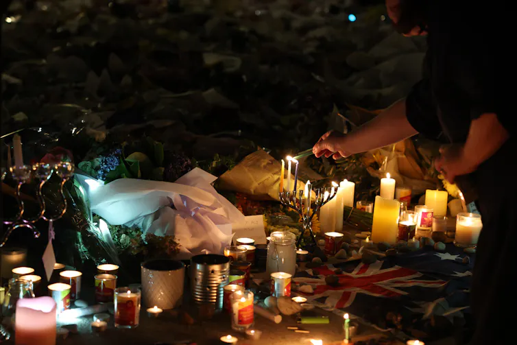 Memorial candles are lit in the dark