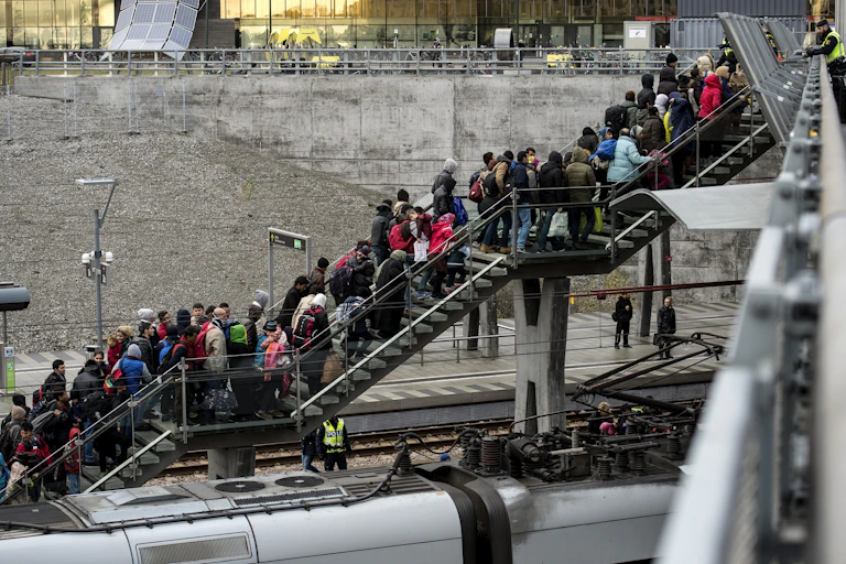 A line of people on stairs at a train station