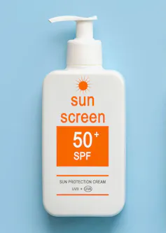 A pump bottle of SPF 50 sunscreen against a blue background