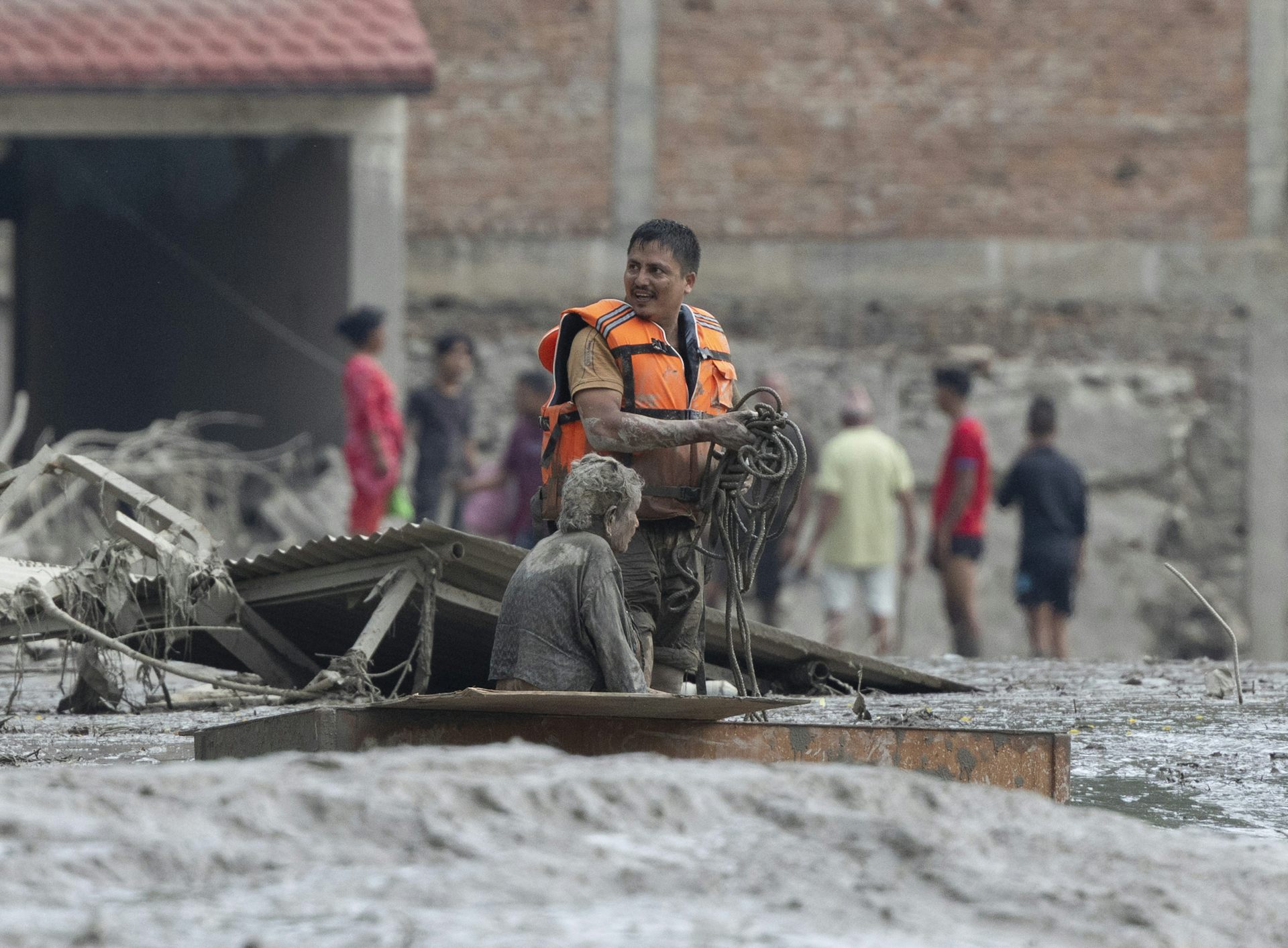 Rescuers transport an elderly woman following a flash flood in Nepal's Nuwakot district.