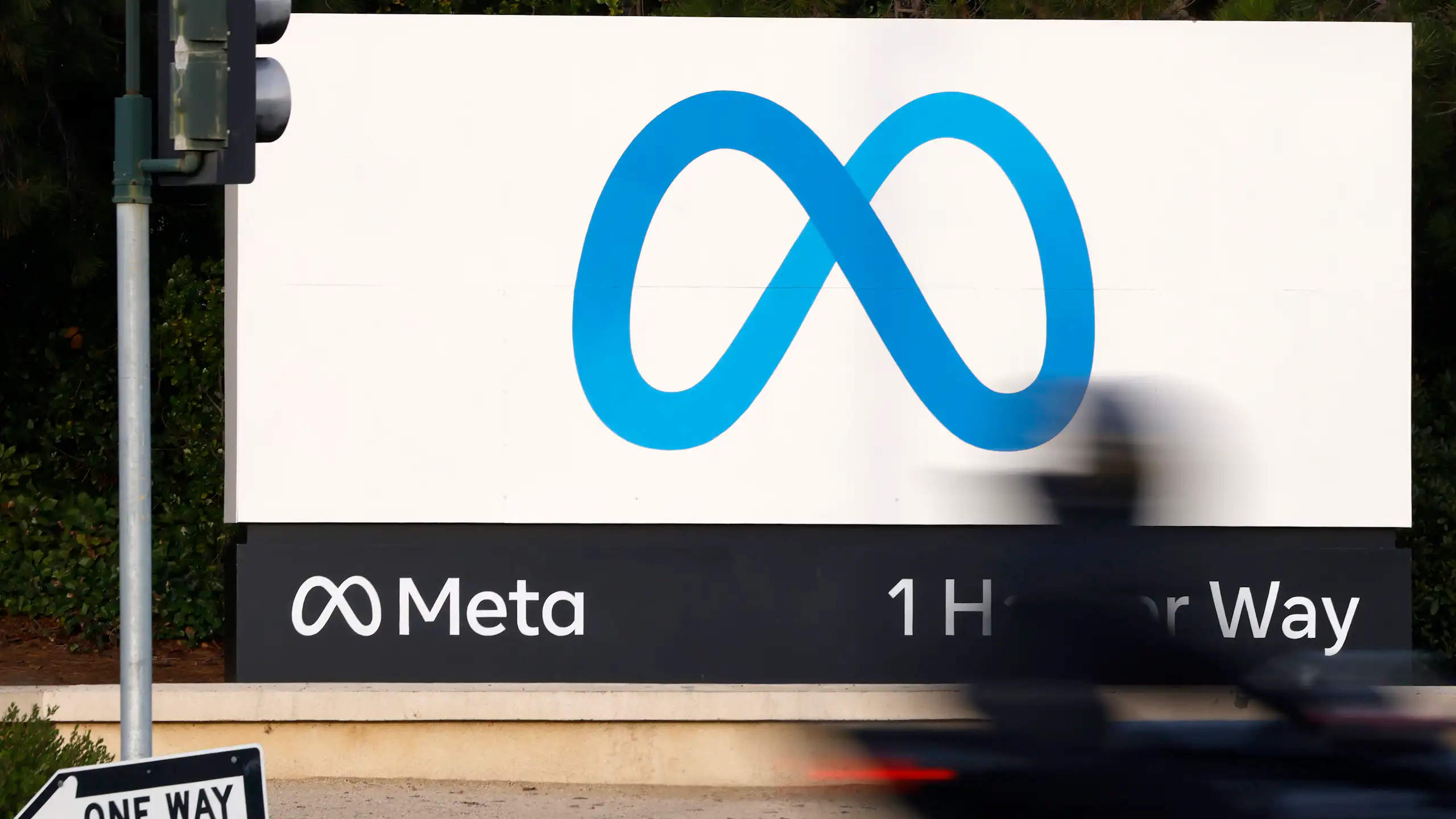 A blue figure-eight shaped logo on a white billboard.