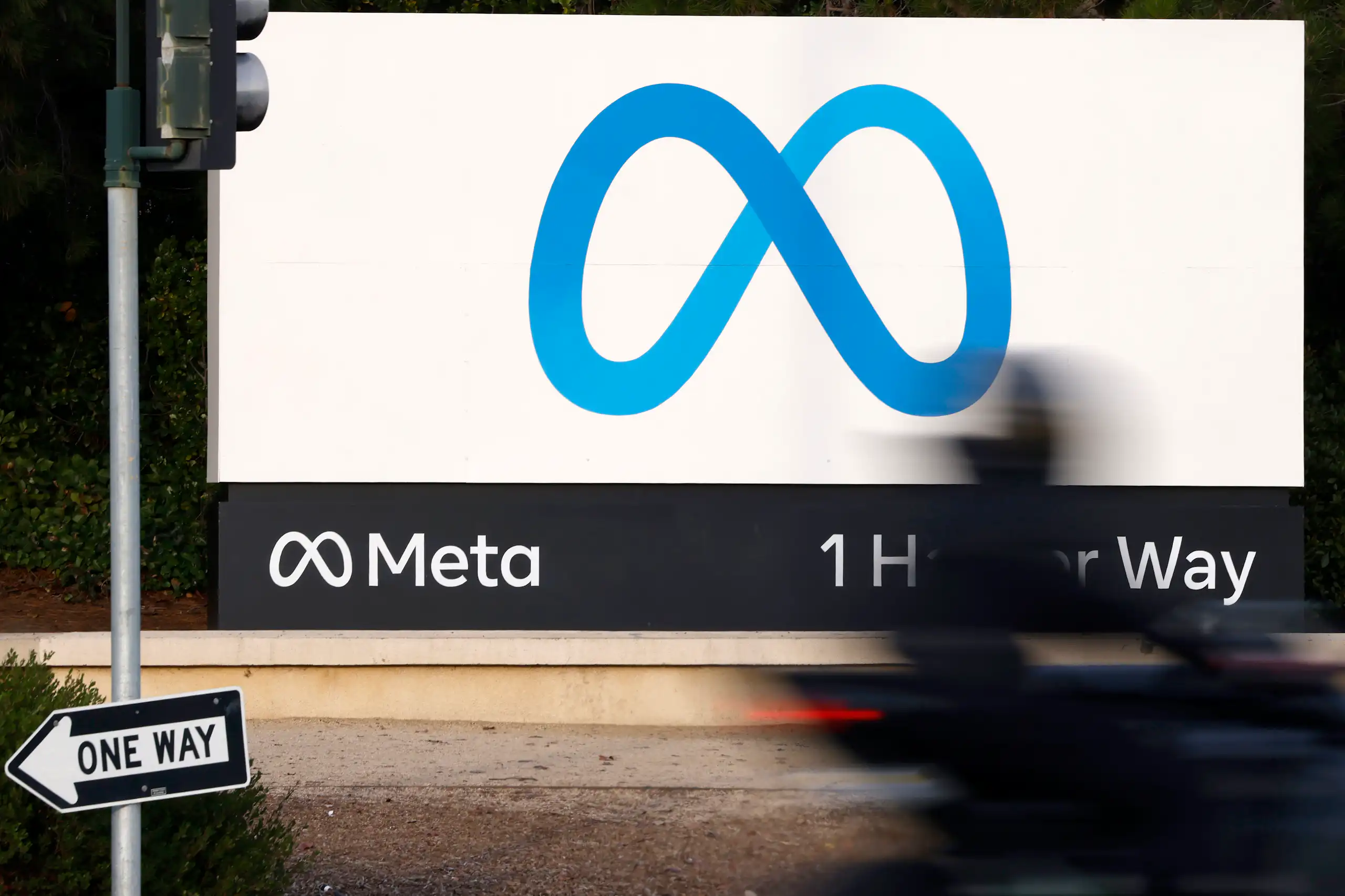 A blue figure-eight shaped logo on a white billboard.