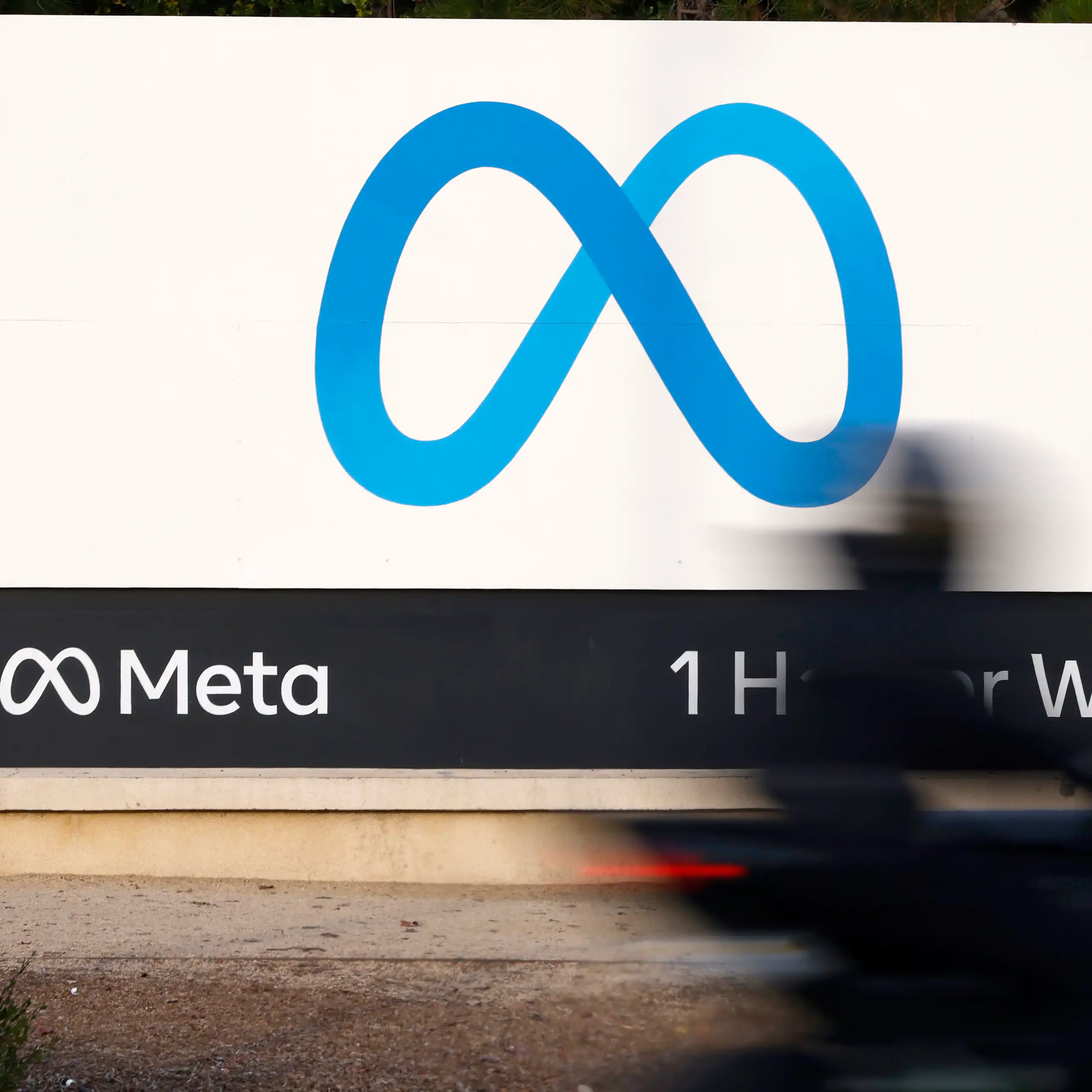 A blue figure-eight shaped logo on a white billboard.