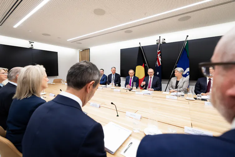 Anthony Albanese and other federal politicians sit around a big desk.