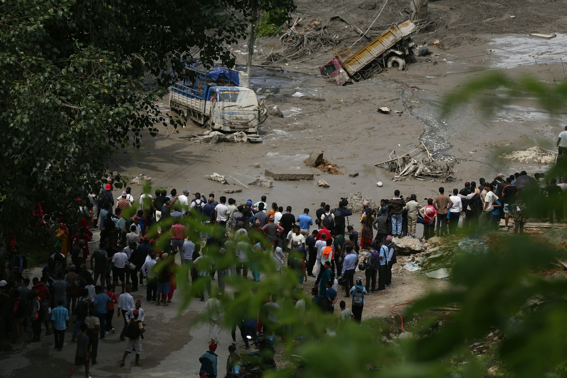 People stare at a flood-damaged section of a highway in Nuwakot, central Nepal, following the flooding.