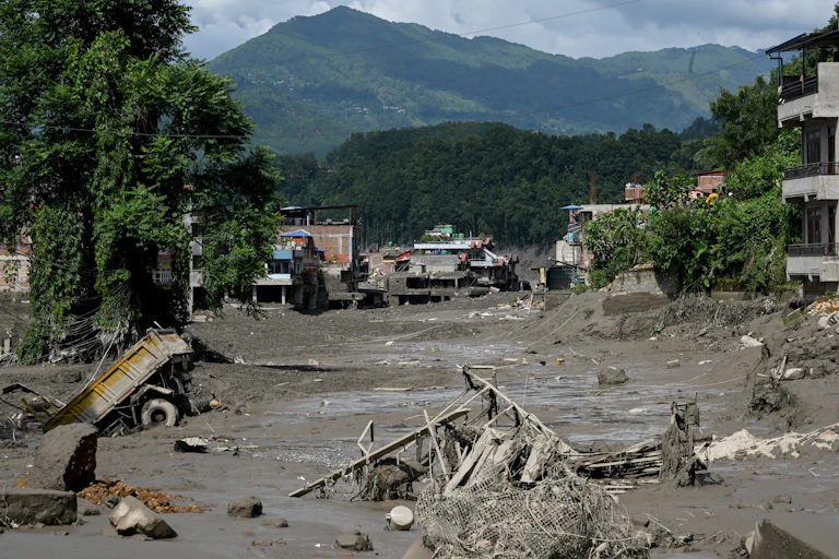 aftermath of flood, mud and broken buildings.