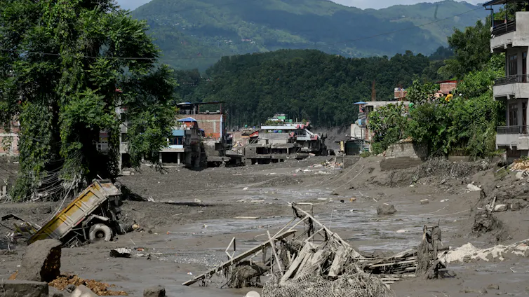 aftermath of flood, mud and broken buildings.
