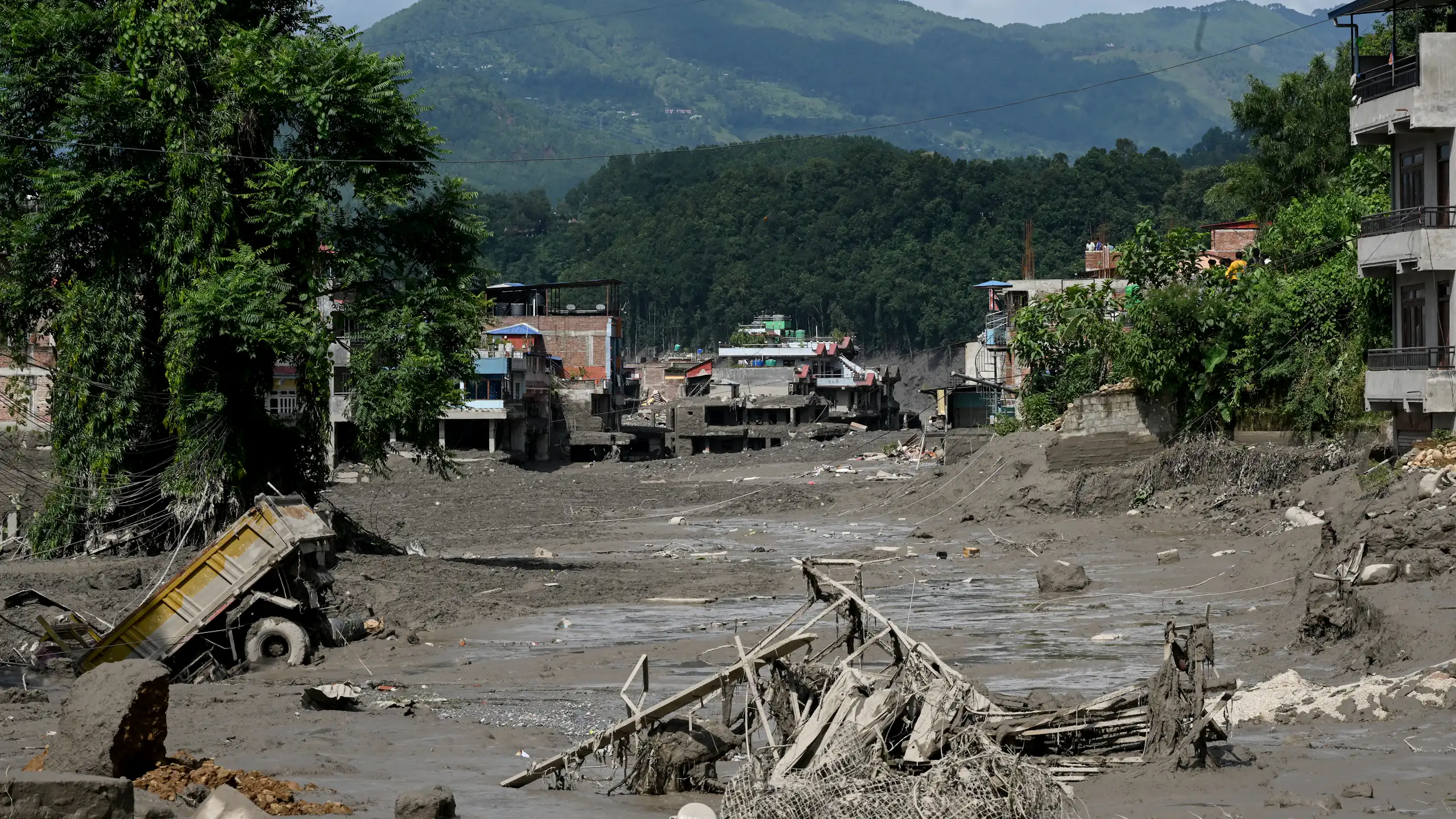 aftermath of flood, mud and broken buildings.
