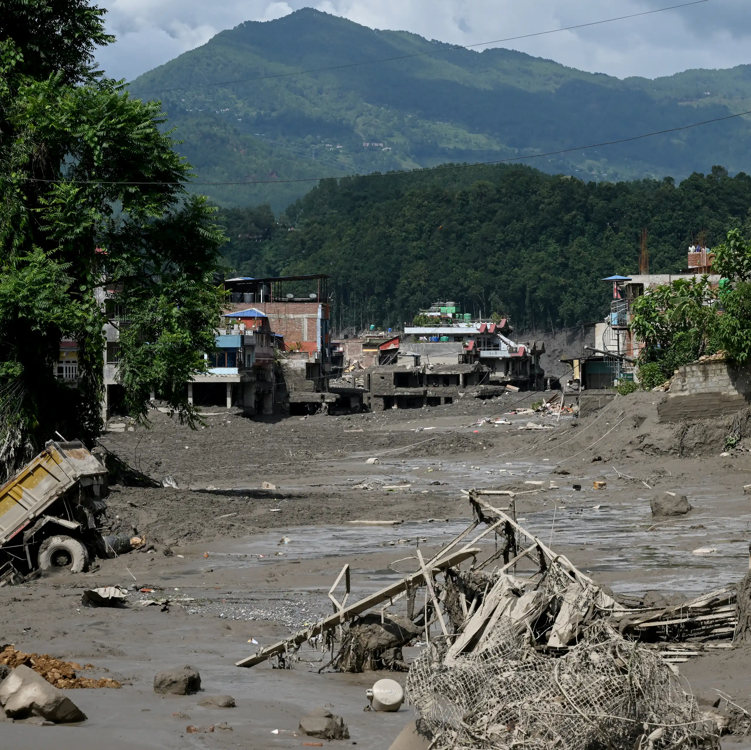 aftermath of flood, mud and broken buildings.