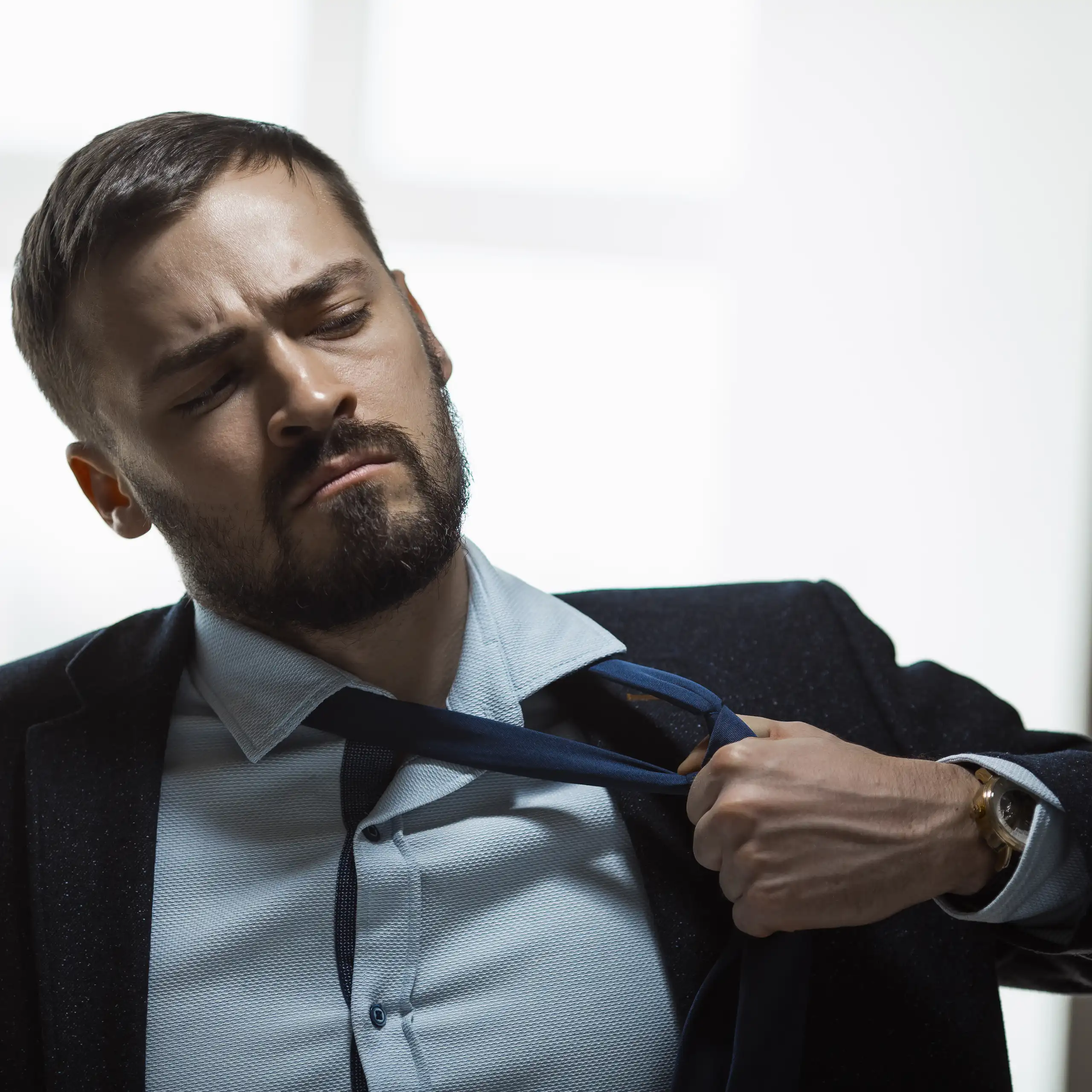 Un homme défaisant son nœud de cravate.