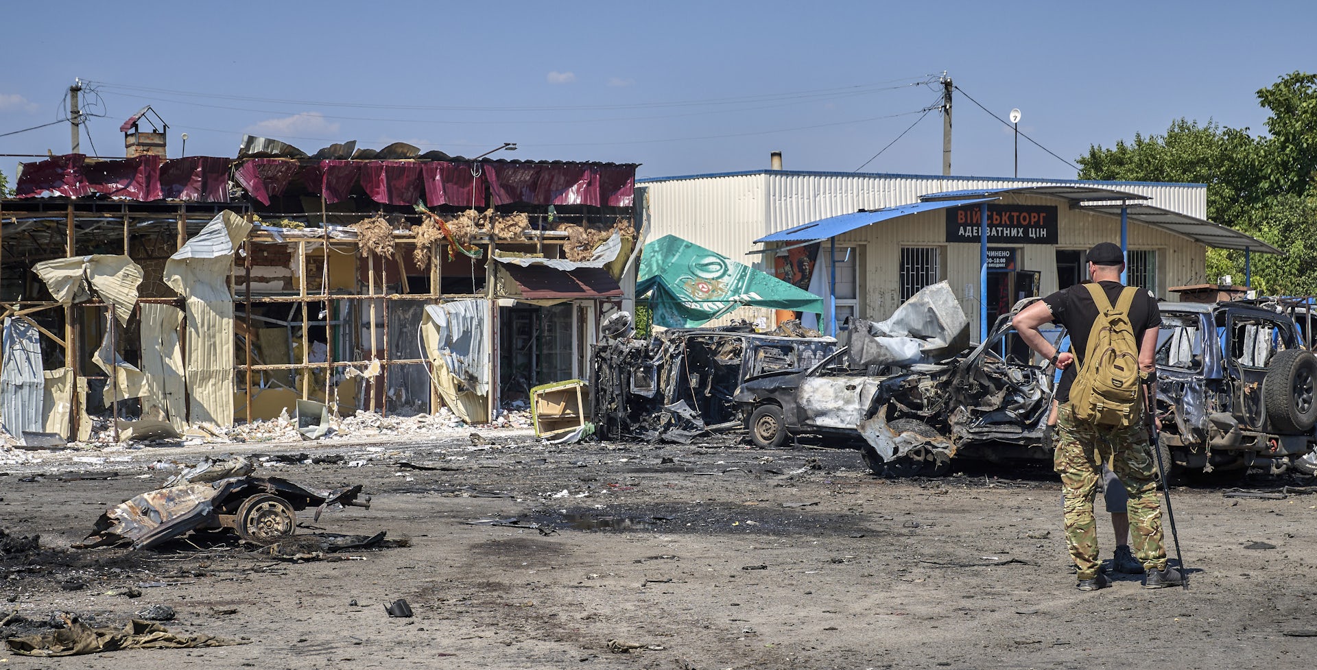 A man observing a building destroyed by a Russian missile strike.