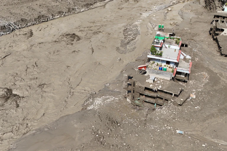 destroyed buildings buried in mud