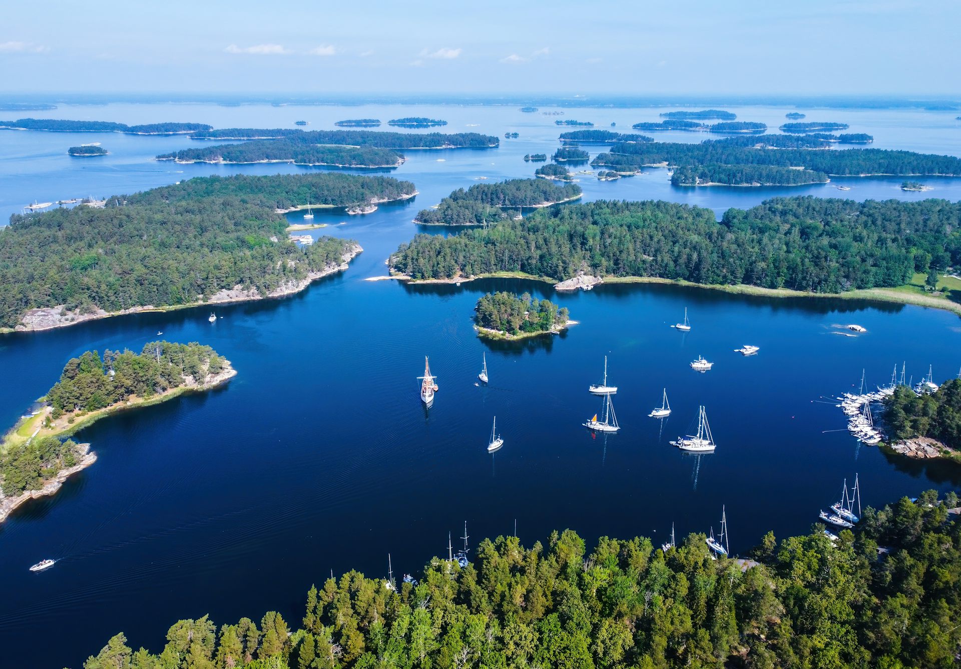 aerial view of island chain and assembled yachts off the coast of stockholm, sweden.