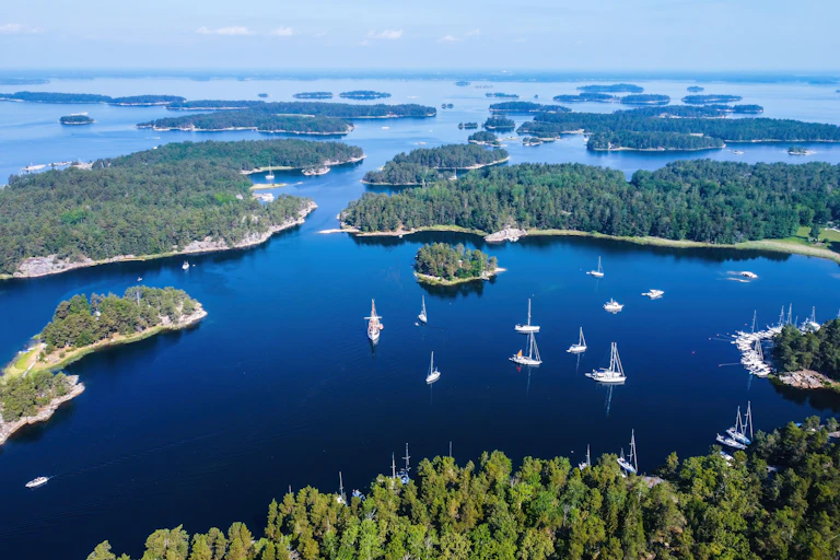 aerial view of island chain and assembled yachts off the coast of stockholm, sweden.