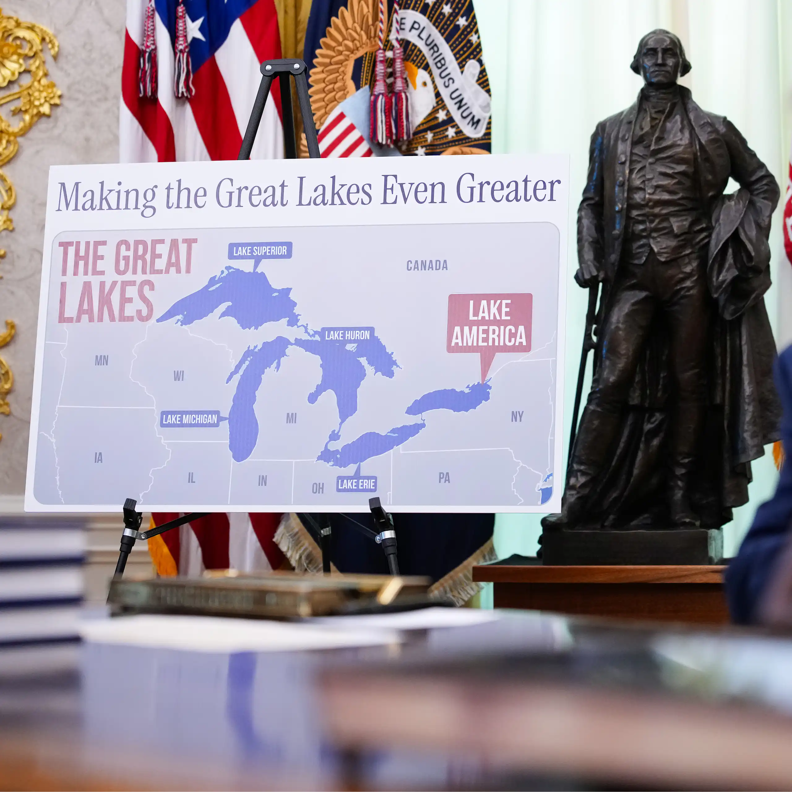 A map labeling Lake Ontario as 'Lake America' is displayed in the Oval Office as President Donald Trump presents an executive order.