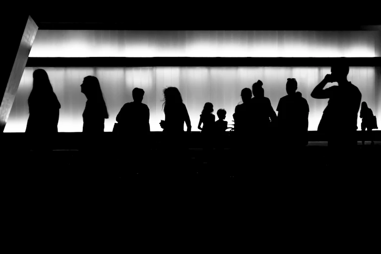 Silhouetted men and women.