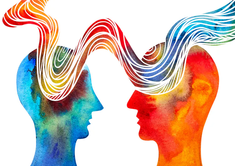 A drawing depicting two silhouetted human heads, with a wave of light running between the both.