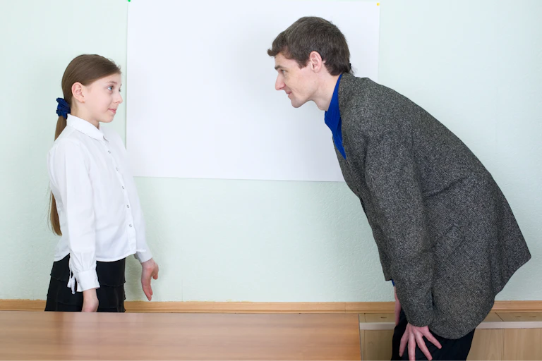 A little girl apologizes to her teacher