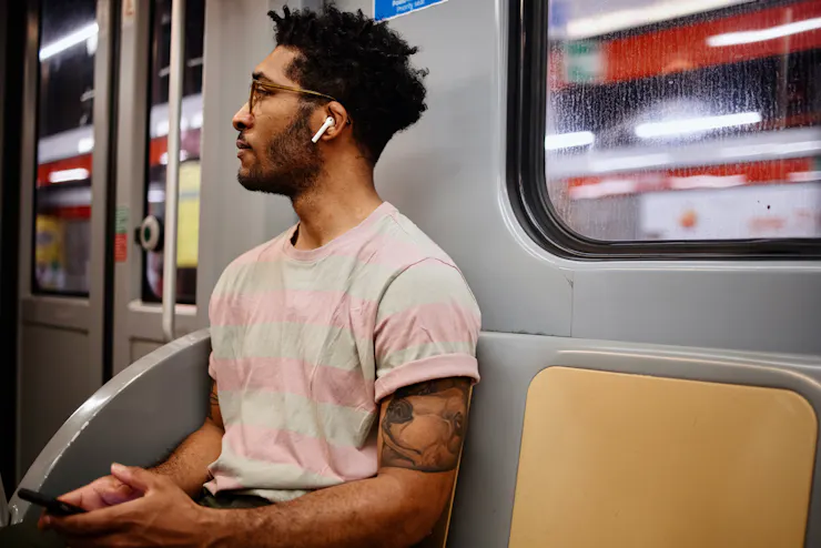 man on subway wearing earbuds
