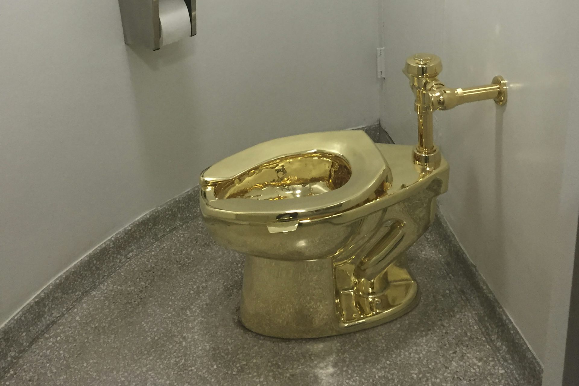 Gold public-bathroom-style toilet in room
