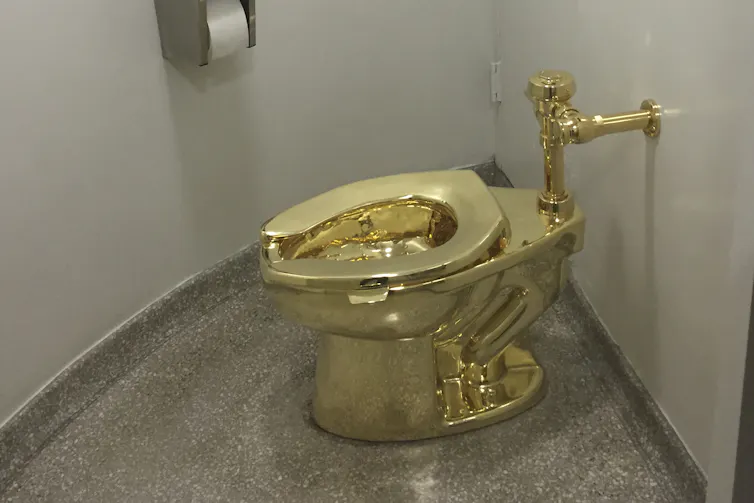 Gold public-bathroom-style toilet in room