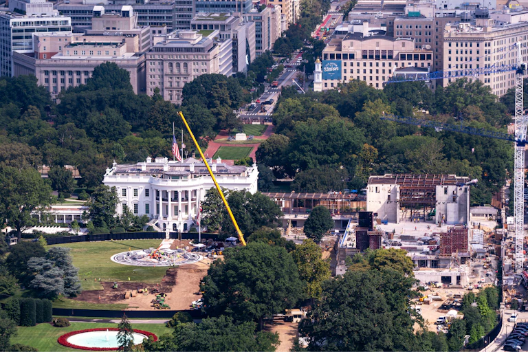 the white house stands next to a site under counstruction
