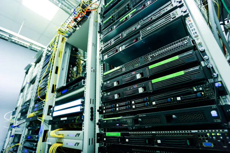 A high-tech server rack in a data centre with network cables and hardware components