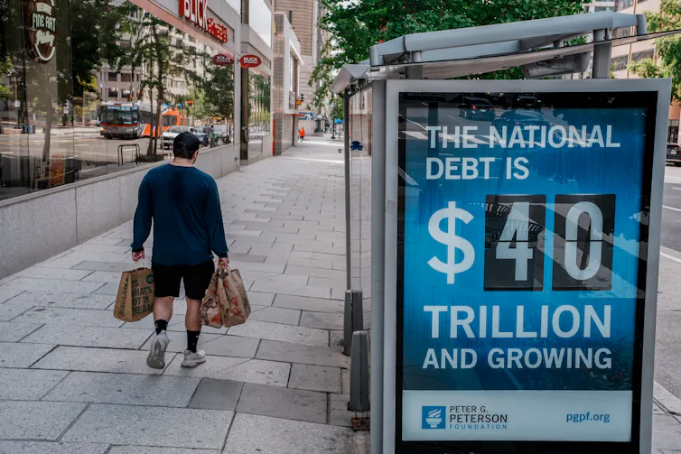 A bus shelter in Washington DC displays the US government debt.
