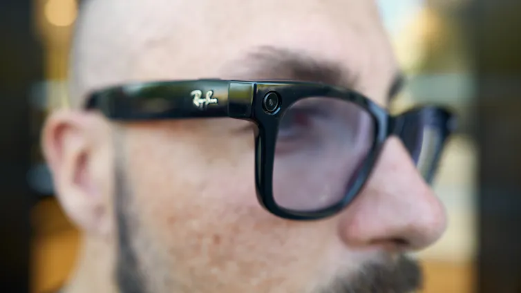 A close up of a man wearing Ray Ban Meta smart glasses, which can be used for recording