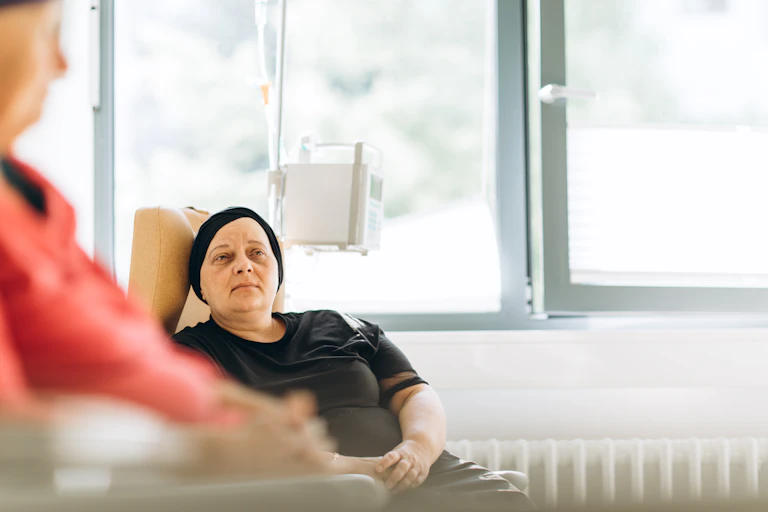 A woman with cancer receives treatment in a clinic