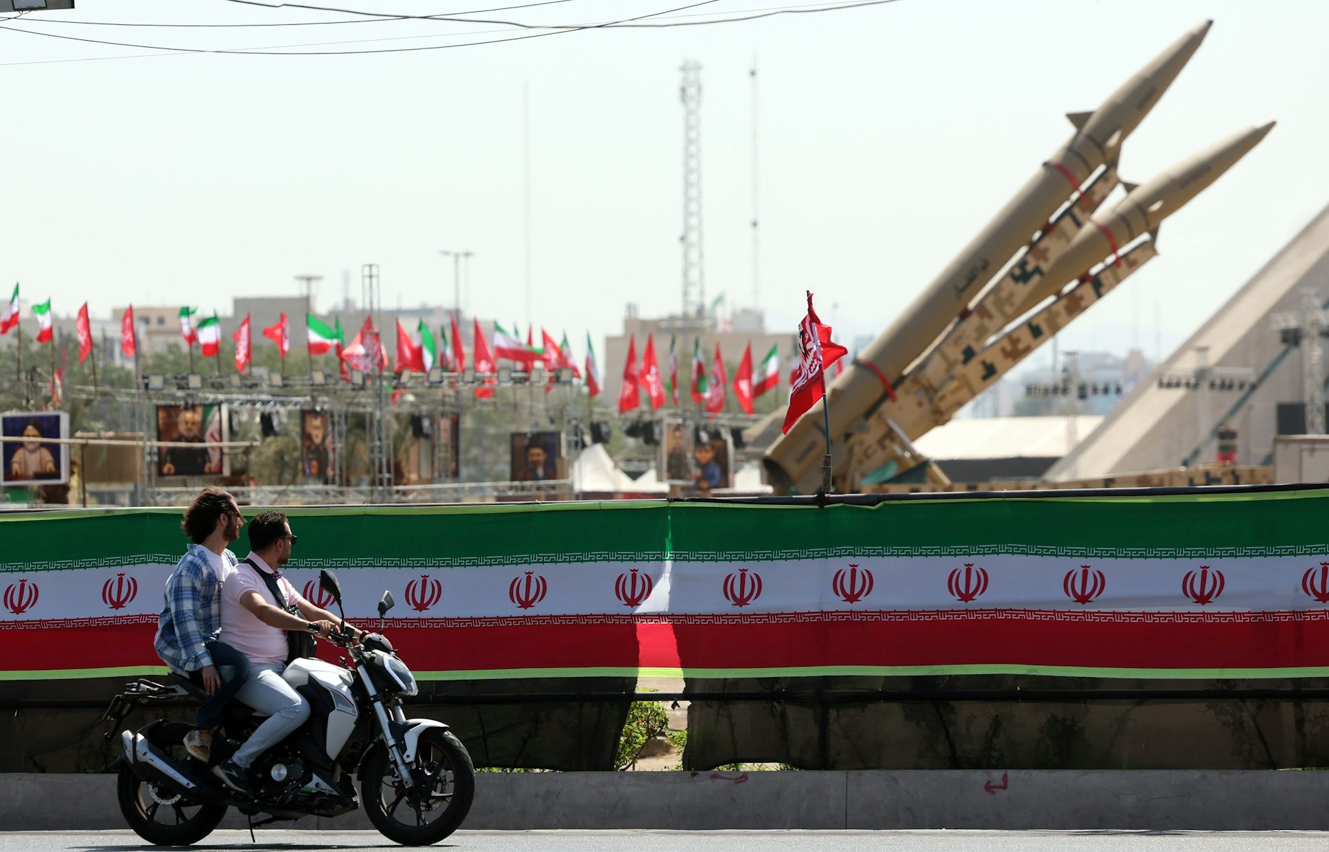 Motorcyclists drive past Iranian missiles on display at Azadi Square in Tehran, Iran, on July 30 2026. Abedin Taherkenareh/EPA