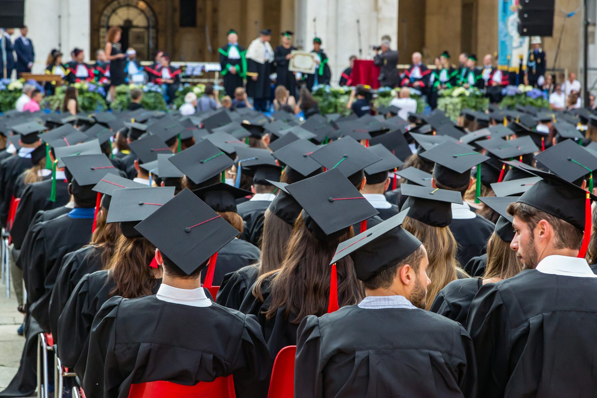  Graduates gather in academic dress and mortarboard caps on Brescia’s Piazza della loggia.