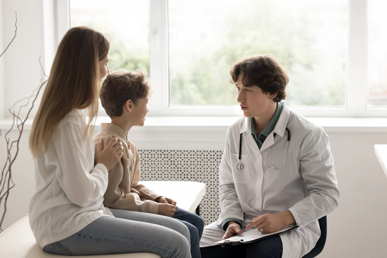 Una madre y su hijo en la consulta de un médico
