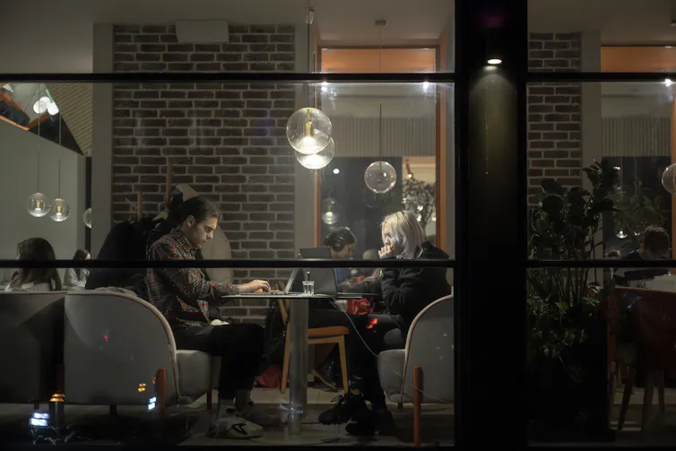 People working on their laptops in a cafe in Kyiv.