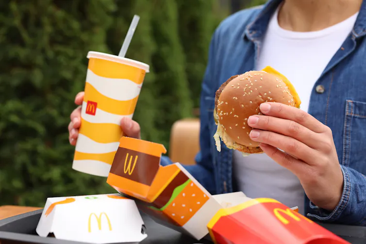 A person eating a McDonalds.