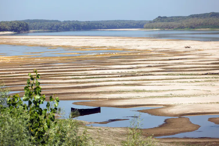 sandbars and low river level, empty boat in foreground.