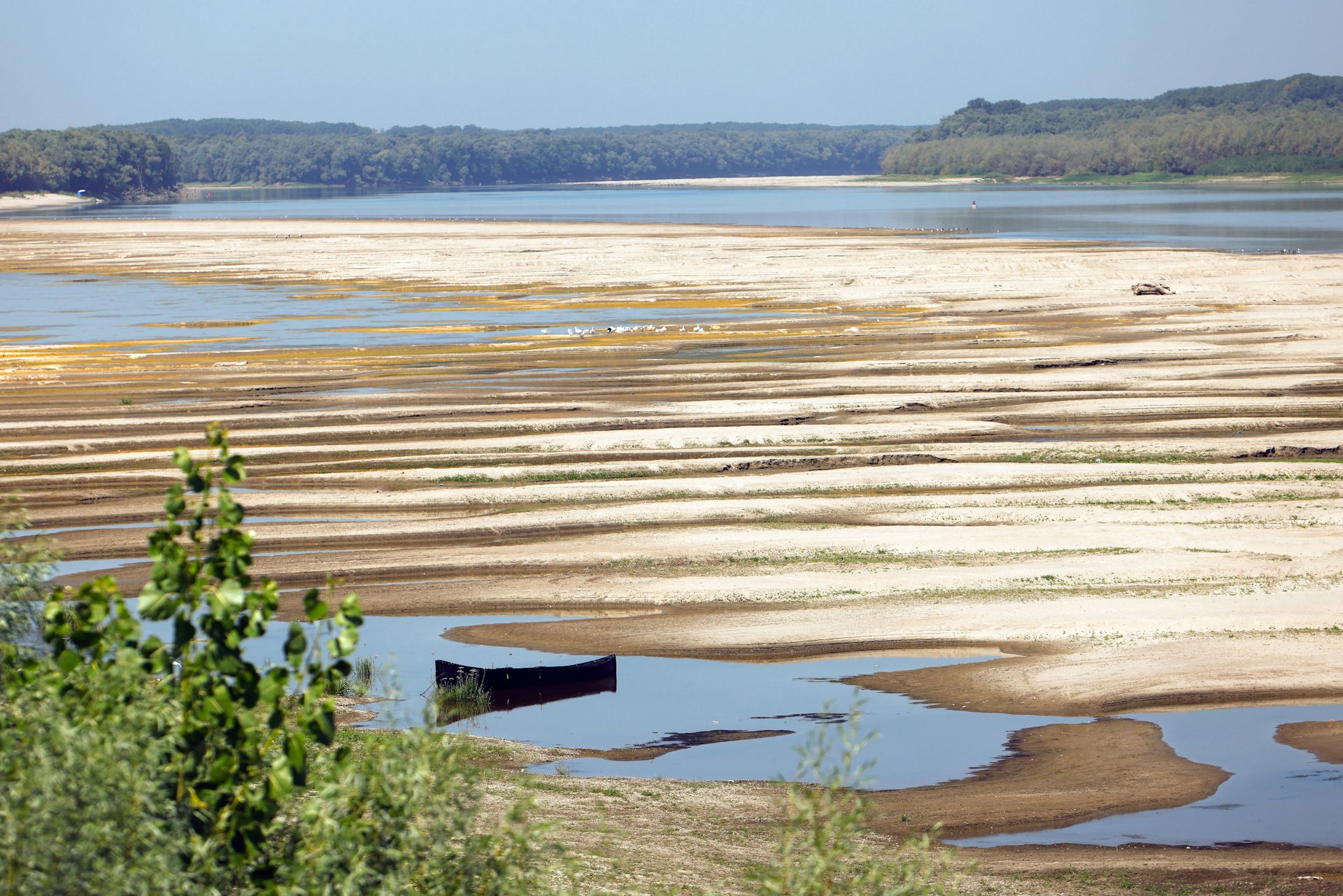 sandbars and low river level, empty boat in foreground.