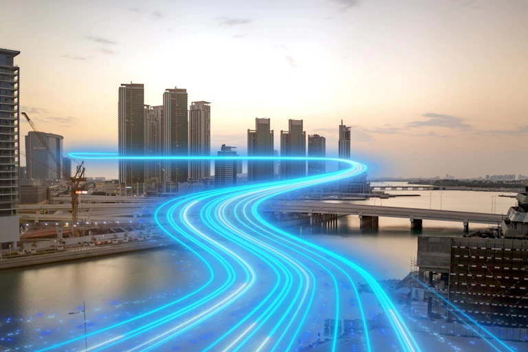 Glowing beams appear to travel towards skyscrapers.