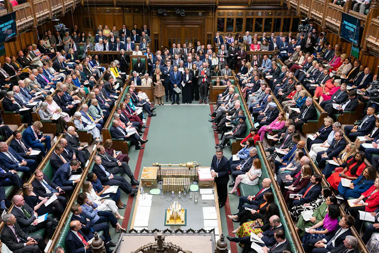 andy burnham in the commons during his first prime minister's questions surrounded by hundreds of mps on either side of the chamber.