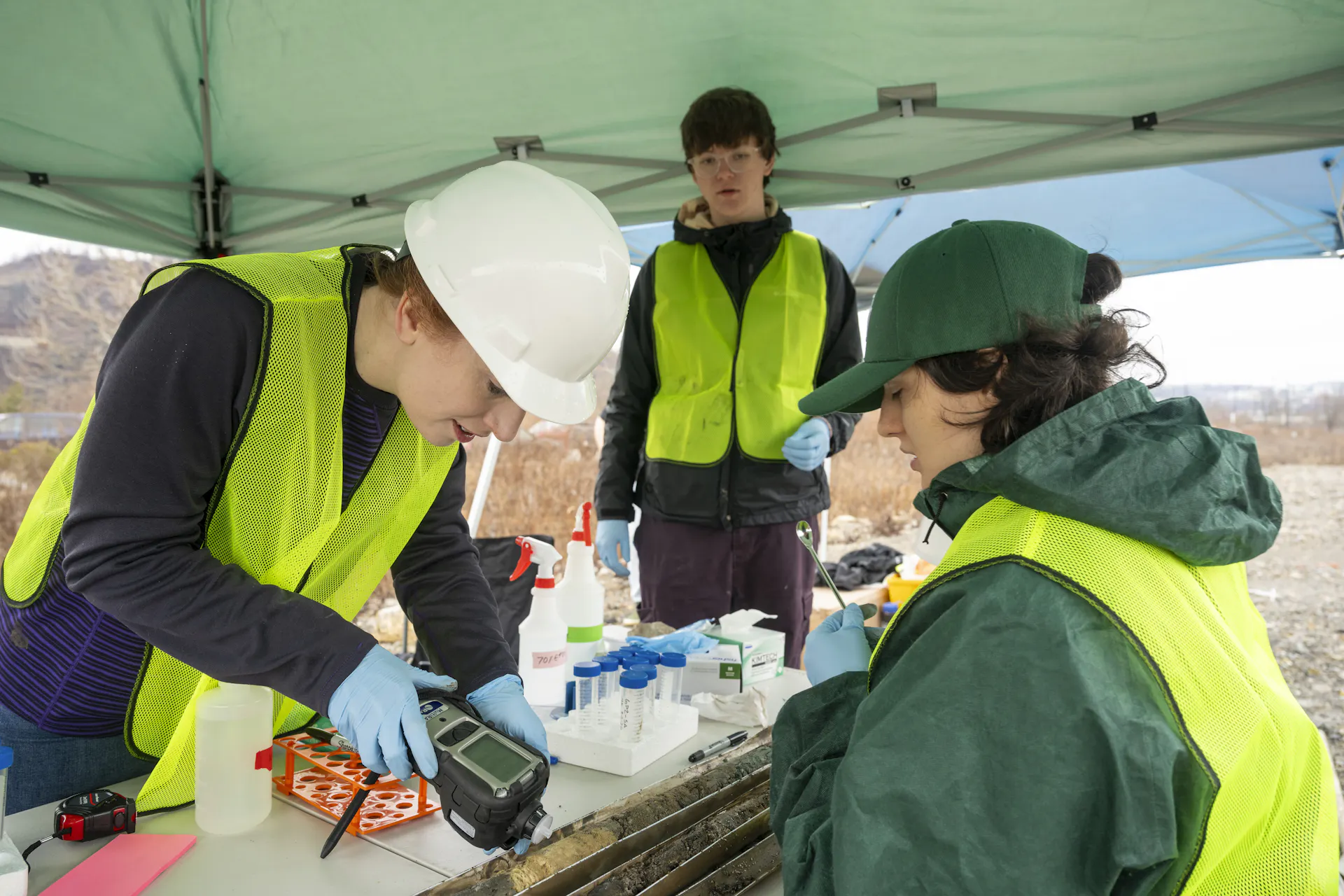 A scientist scans a soil sample with a digital tool.
