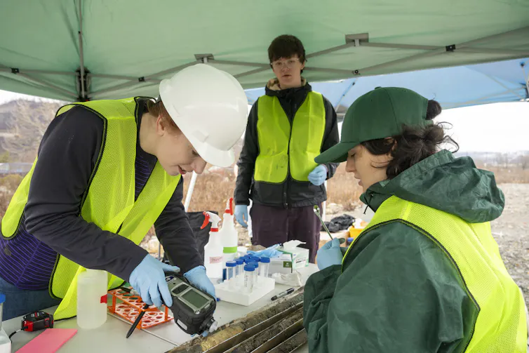 A scientist scans a soil sample with a digital tool.