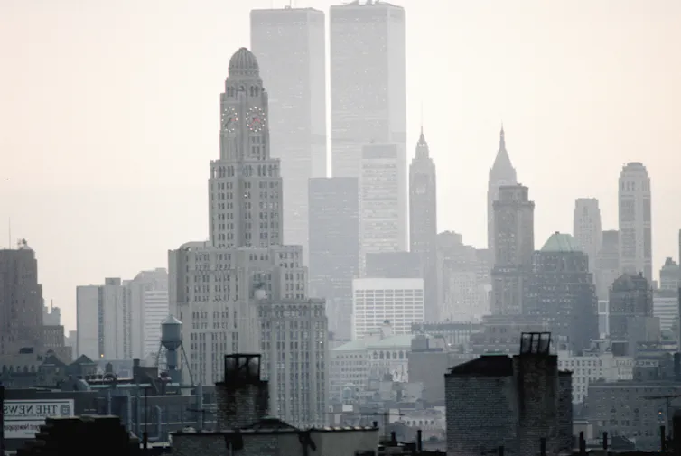 View of Manhattan towers, with the Empire State Building in the foreground and the Twin Towers behind.