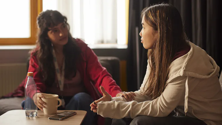 A woman talks to her friend about her mental health