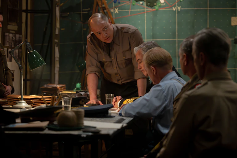 army officers stand around table looking stressed