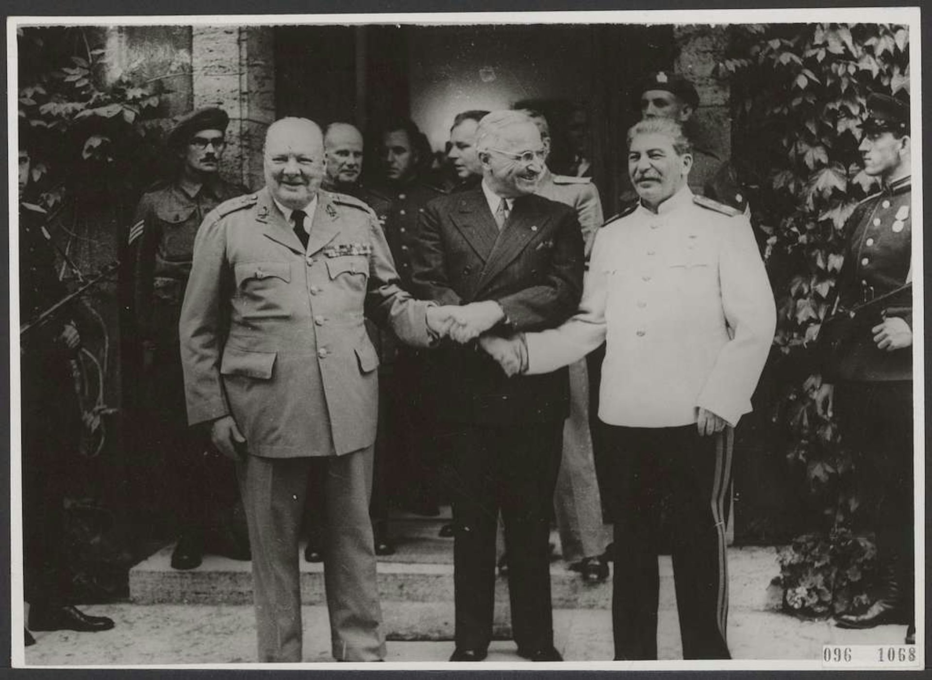US president, Harry Truman, joins hands with Winston Churchill and Josef Stalin.