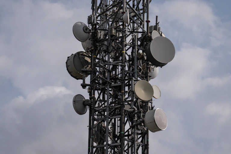 numerous disk-shaped objects attached to a metal tower at various angles
