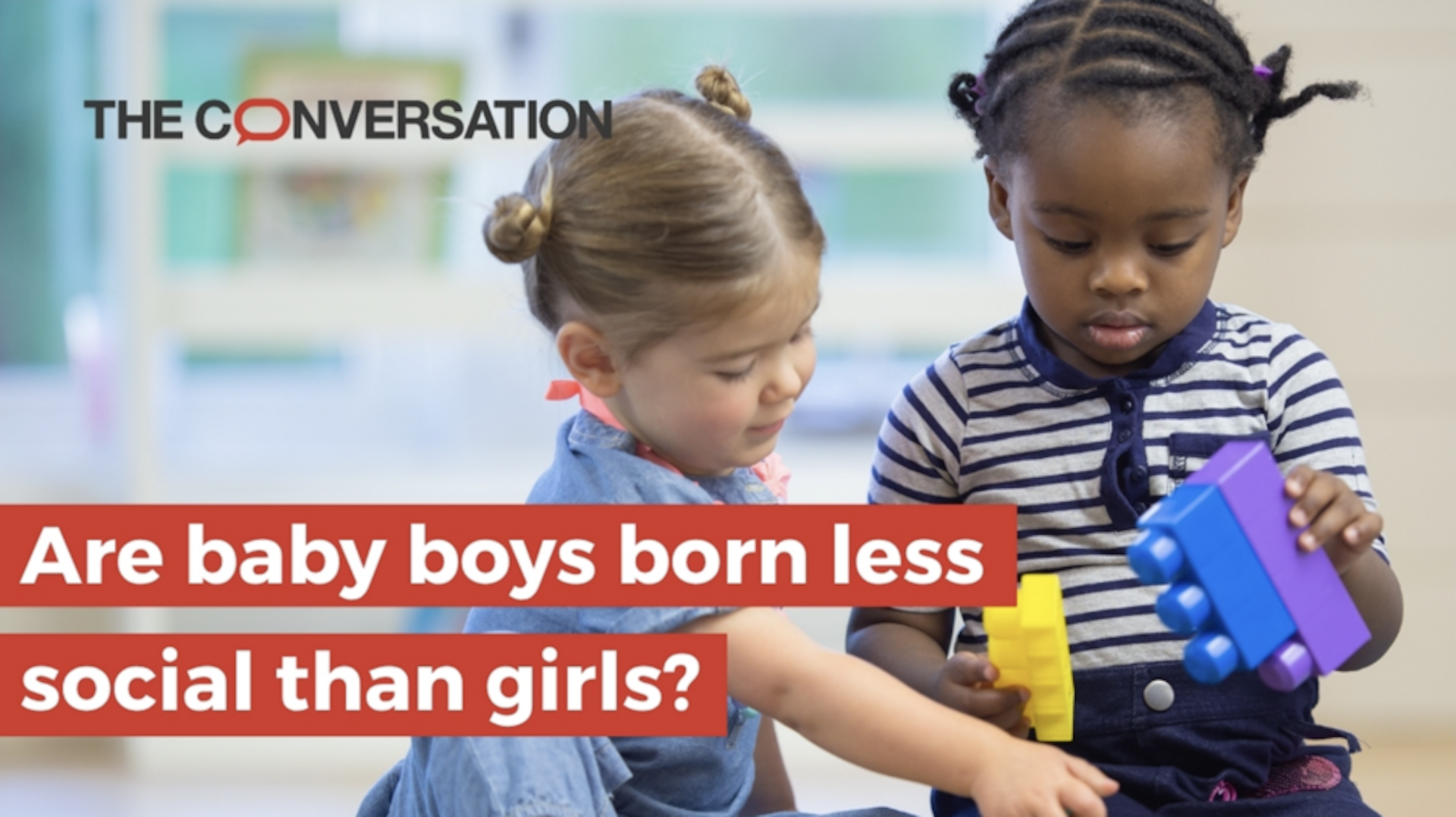 Two young children, a boy and a girl, play with building blocks together behind text that says "Are baby boys born less social than girls?"