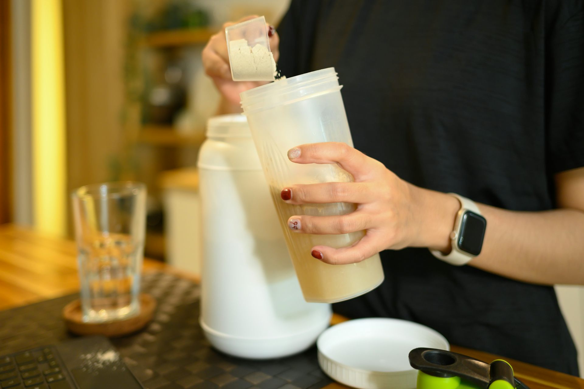 A woman prepares a protein drink.