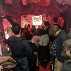 People standing inside a room decorated to look like a womb.